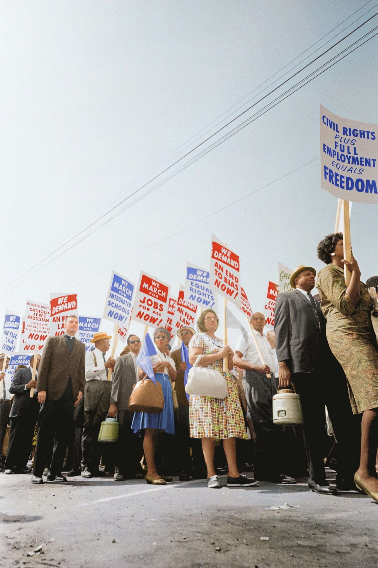 A photograph of a historic civil rights march with protest signs.