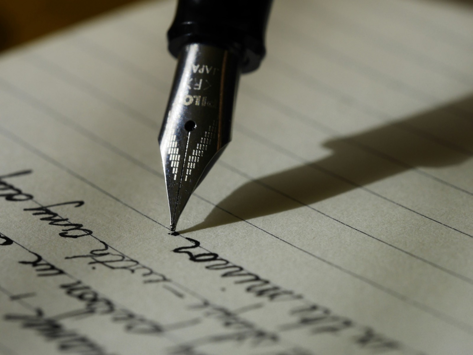 A person writing at a desk.